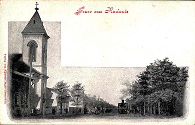 Postcard of a church and a tree-lined street