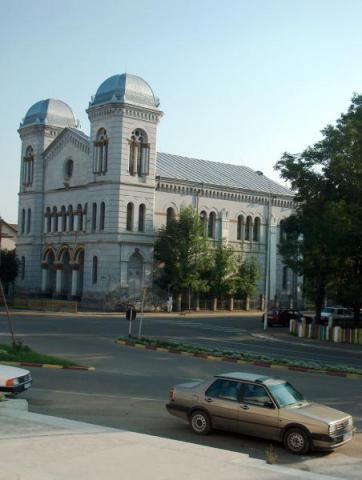 The Temple seen across the square, a parked car in the foreground