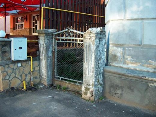 A side gate between weathered pillars