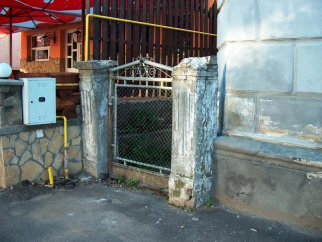 A side gate between weathered pillars