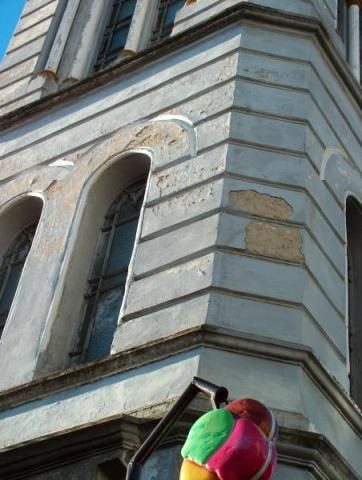 The corner of a tower with tall arched windows