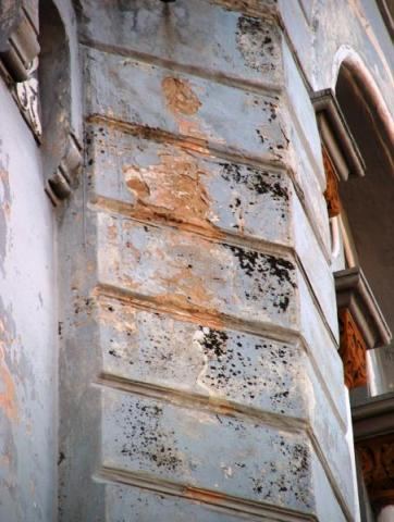 Flaking plaster on the corner of a tower
