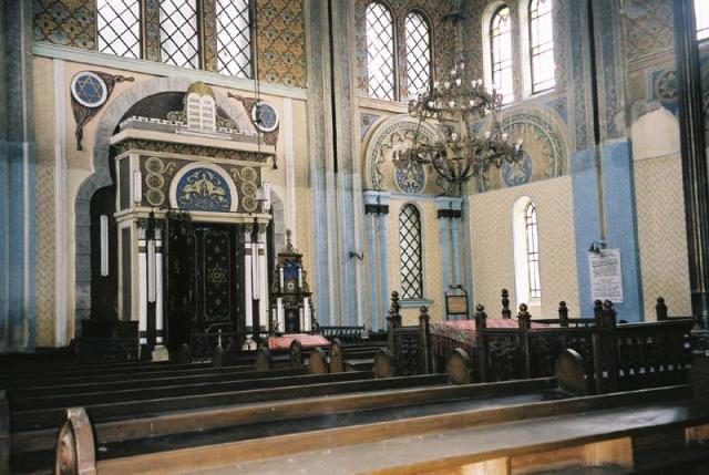 The sanctuary: the Holy Ark, wooden pews and a chandelier