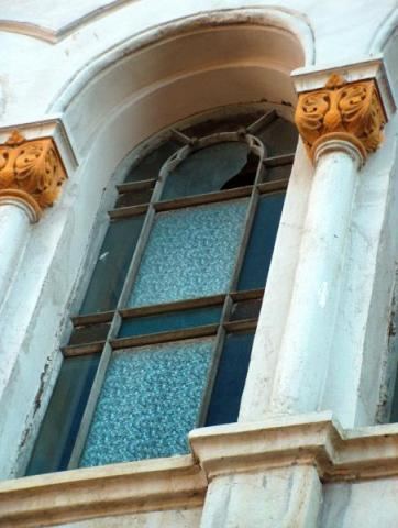 An arched window framed by columns with decorated capitals